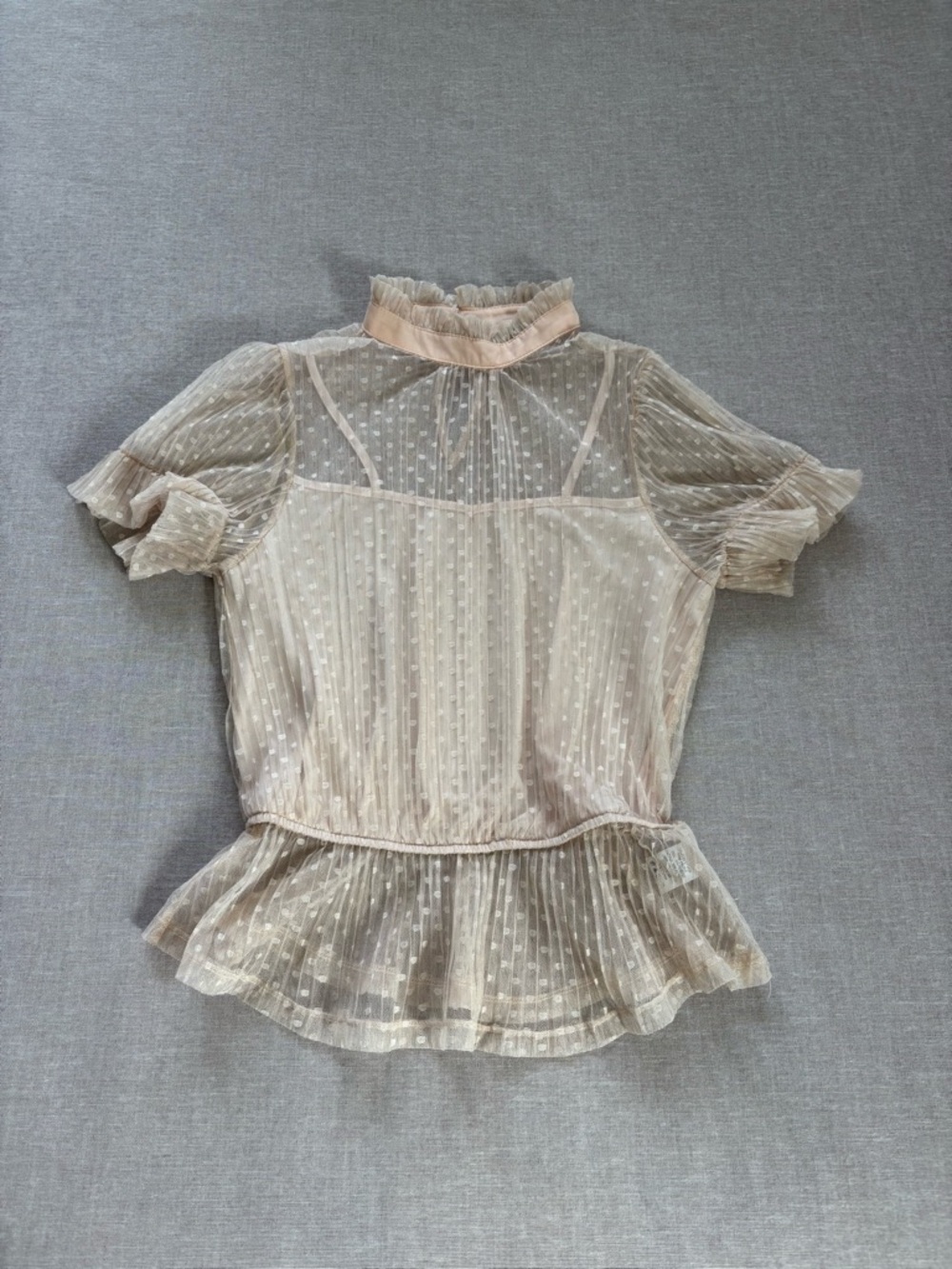 Story On polka dot chiffon ruffle top.